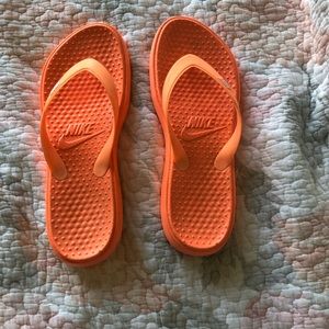 Nike neon orange flip flops